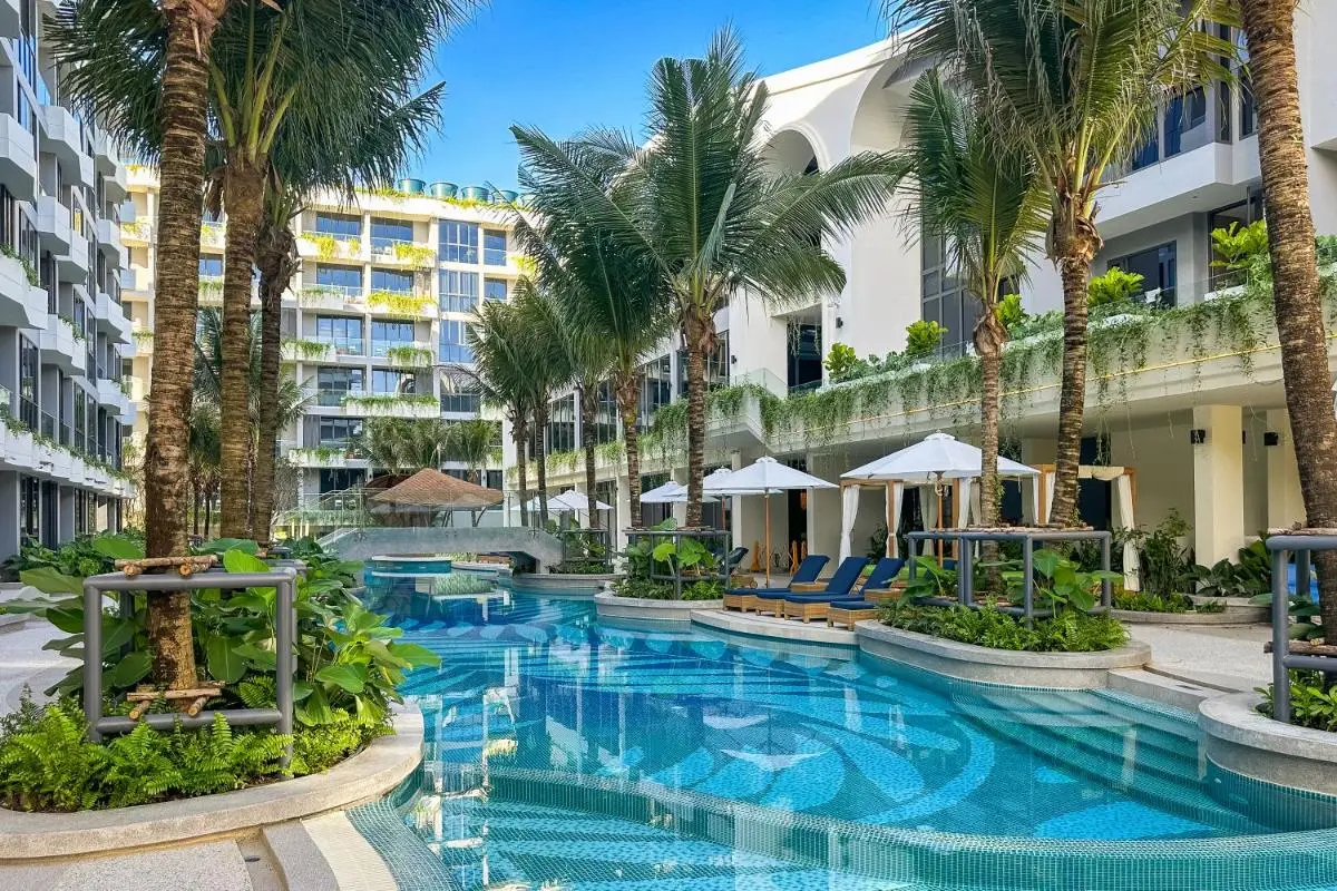Outdoor Freeform Pool with Palm Trees and Lounge Areas at Bang Tao Beach