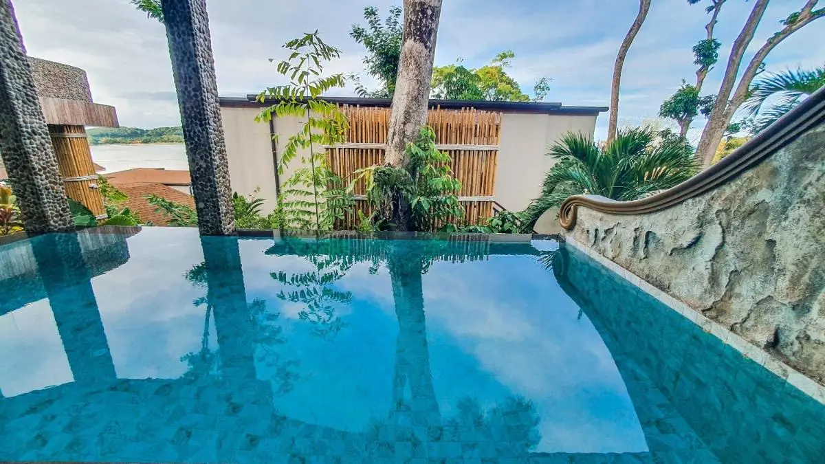 Thailand Outdoor Infinity Pool with Blue Mosaic Tiles and Tropical Surroundings in Phuket Town