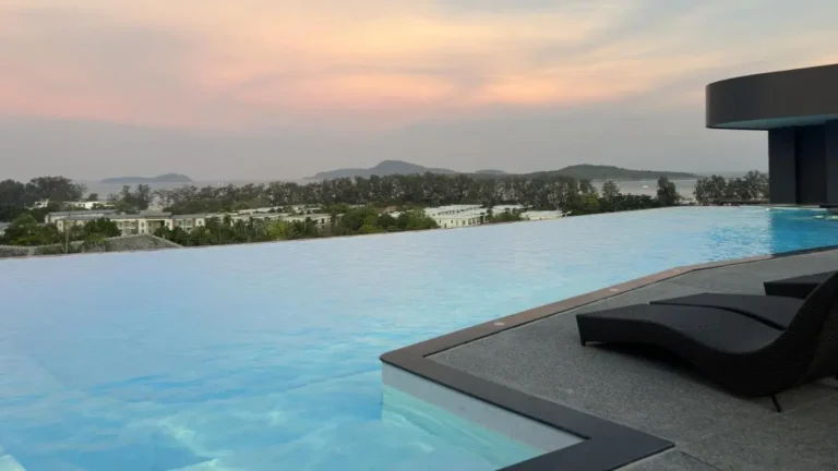 Outdoor Infinity Pool with Coastal Views and Lounge Area at Rawai Beach