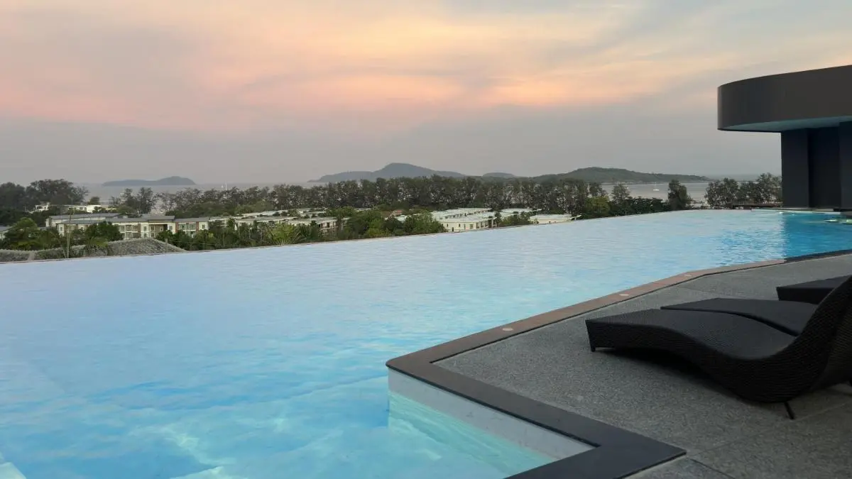 Outdoor Infinity Pool with Coastal Views and Lounge Area at Rawai Beach