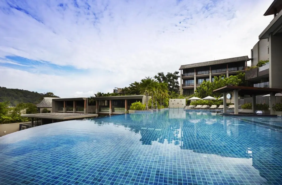 Outdoor Infinity Pool with Lounge Area and Modern Architecture at Patong Beach
