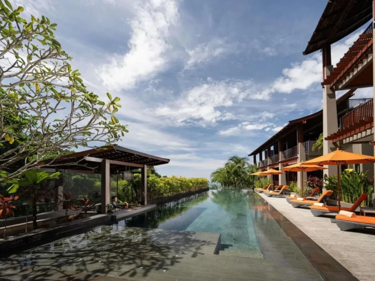 Outdoor Infinity Pool with Lounge Chairs and Pavilion at Tropical Patong Beach