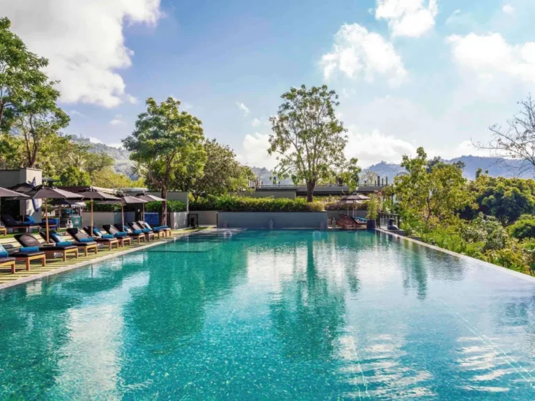 Outdoor Infinity Pool with Lounge Chairs and Scenic Views at Nai Thon Beach Outdoor Infinity Pool with Lounge Chairs and Scenic Views at Nai Thon Beach