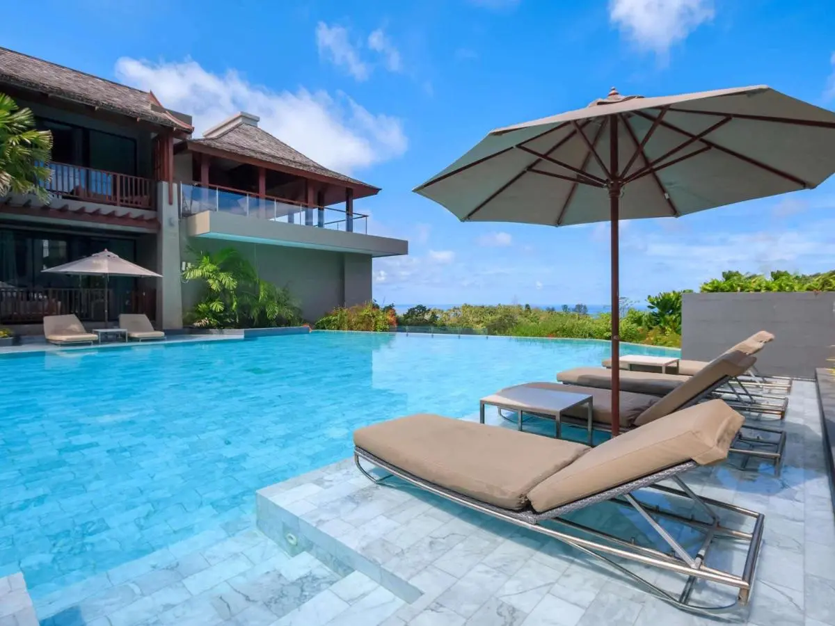 Avista Hideaway Phuket Patong - MGallery Outdoor Infinity Pool with Lounge Chairs and Scenic Views at Patong Beach