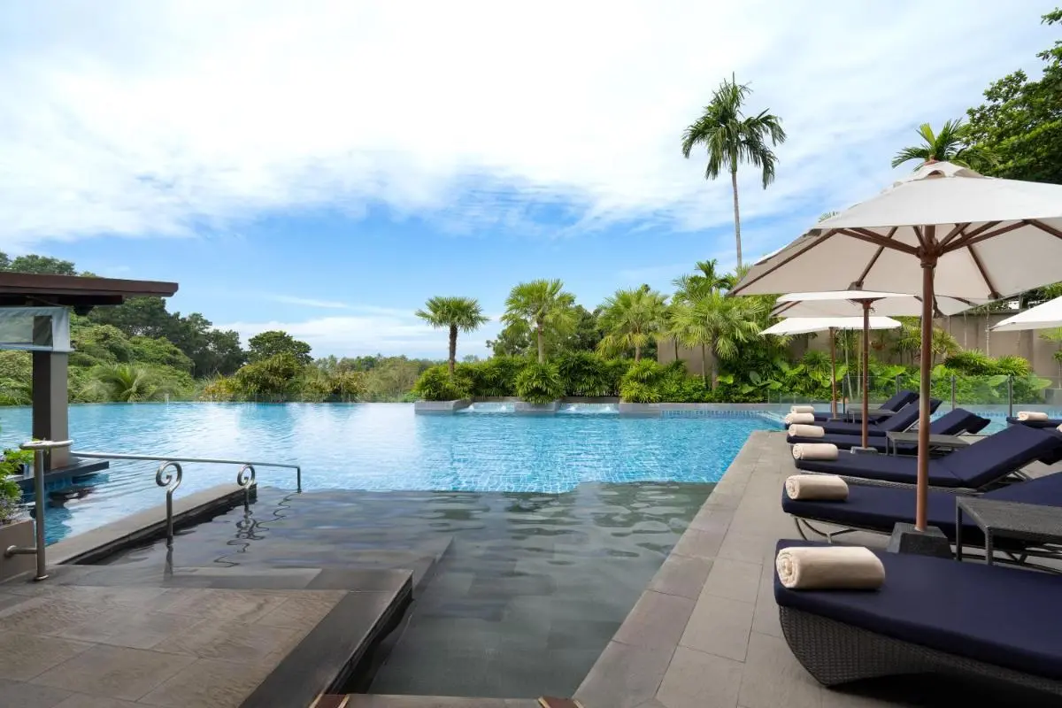 Outdoor Infinity Pool with Lounge Chairs and Tropical Surroundings at Patong Beach