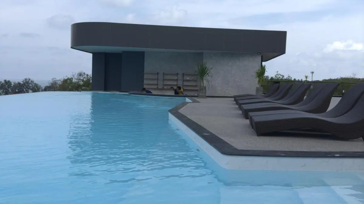 Outdoor Infinity Pool with Modern Lounge Area and Natural Surroundings at Rawai Beach