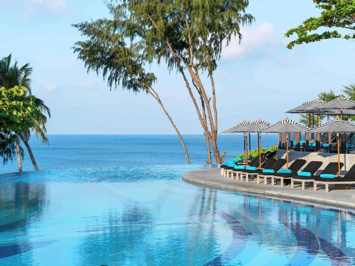 Outdoor Infinity Pool with Ocean Views and Relaxing Lounge Area at Nai Thon Beach