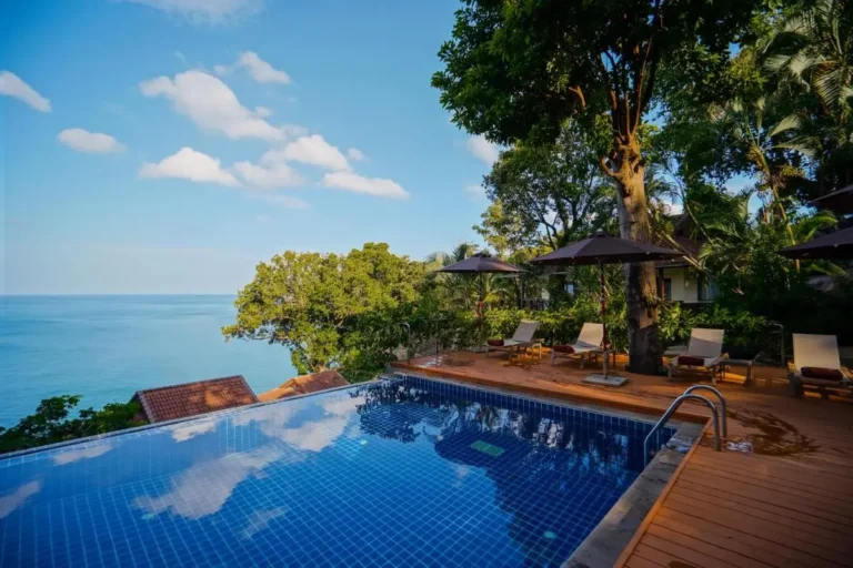 Outdoor Infinity Pool with Ocean Views and Wooden Deck at Karon Beach