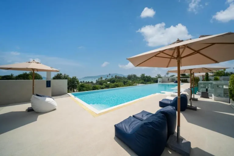 Outdoor Infinity Pool with Scenic Coastal Views and Comfortable Seating at Rawai Beach