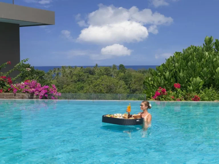 Outdoor Infinity Pool with Scenic Ocean View and Floating Food Tray at Patong Beach