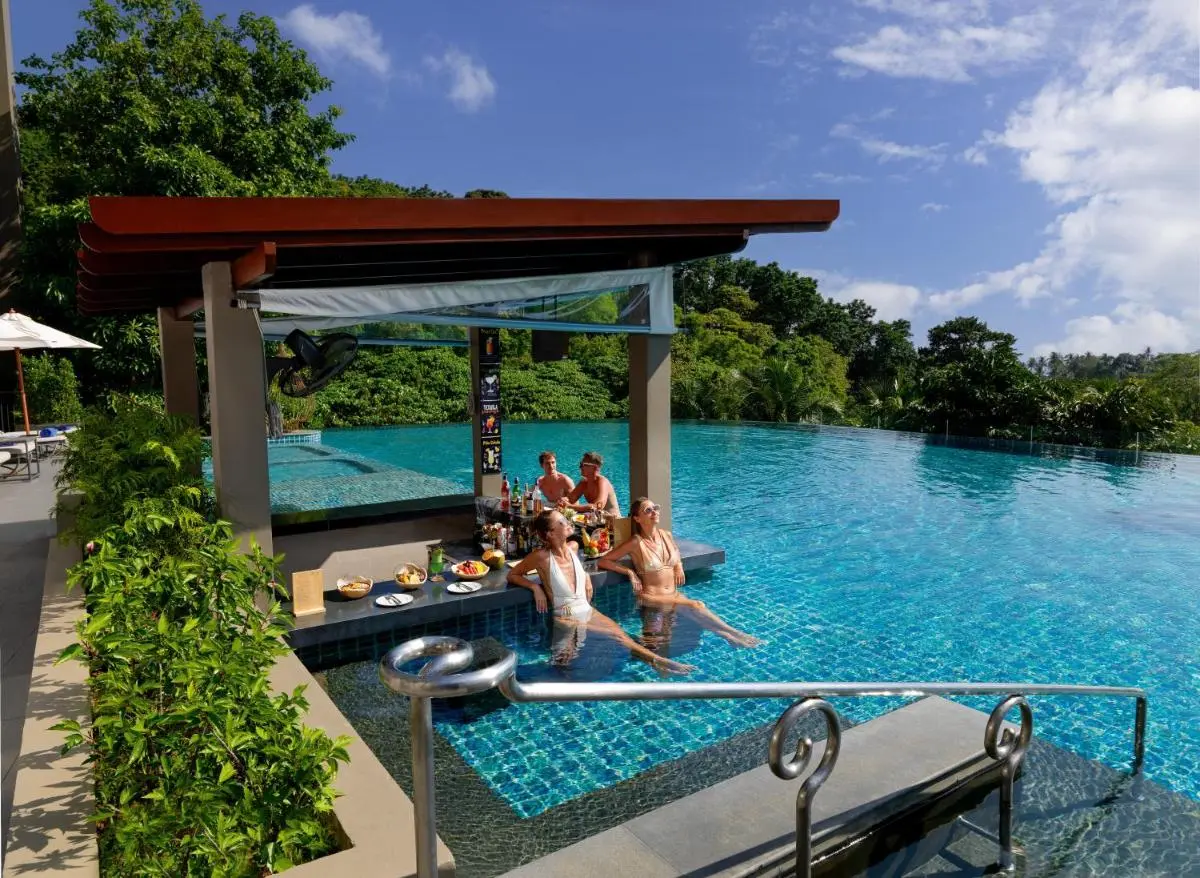 Outdoor Infinity Pool with Swim-Up Bar and Natural Surroundings at Patong Beach