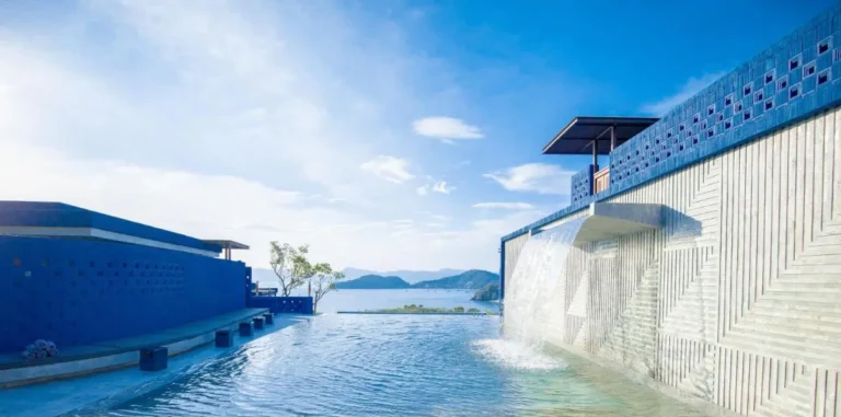 Outdoor Infinity Pool with Waterfall and Scenic Island Views at Panwa Beach