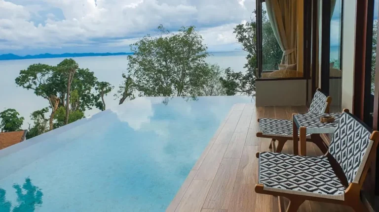Outdoor Infinity Pool with Wooden Deck and Scenic Water Views in Phuket Town
