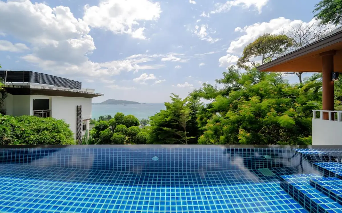 Outdoor Infinity Swimming Pool with Blue Mosaic Tiles and Scenic Sea View at Patong Beach