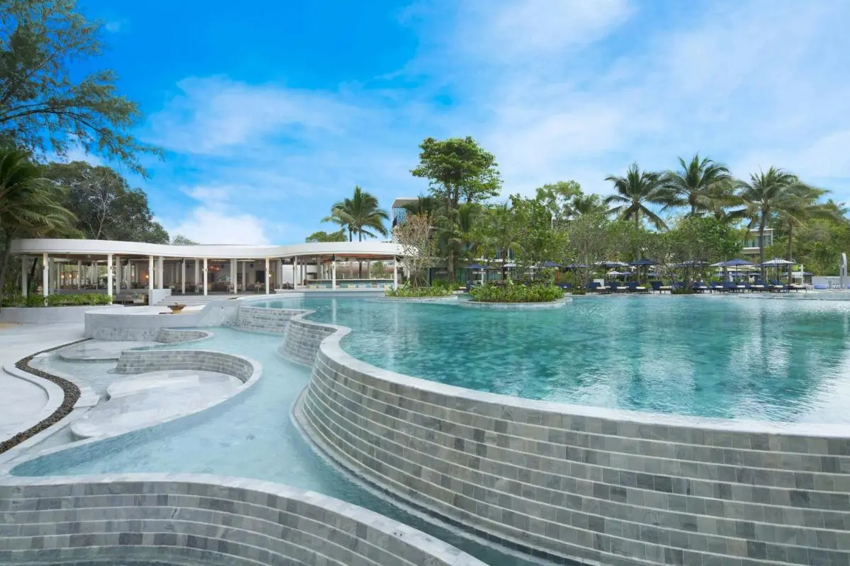 Outdoor Multi-Level Swimming Pool and Lounge Area with Tropical Surroundings at Mai Khao Beach
