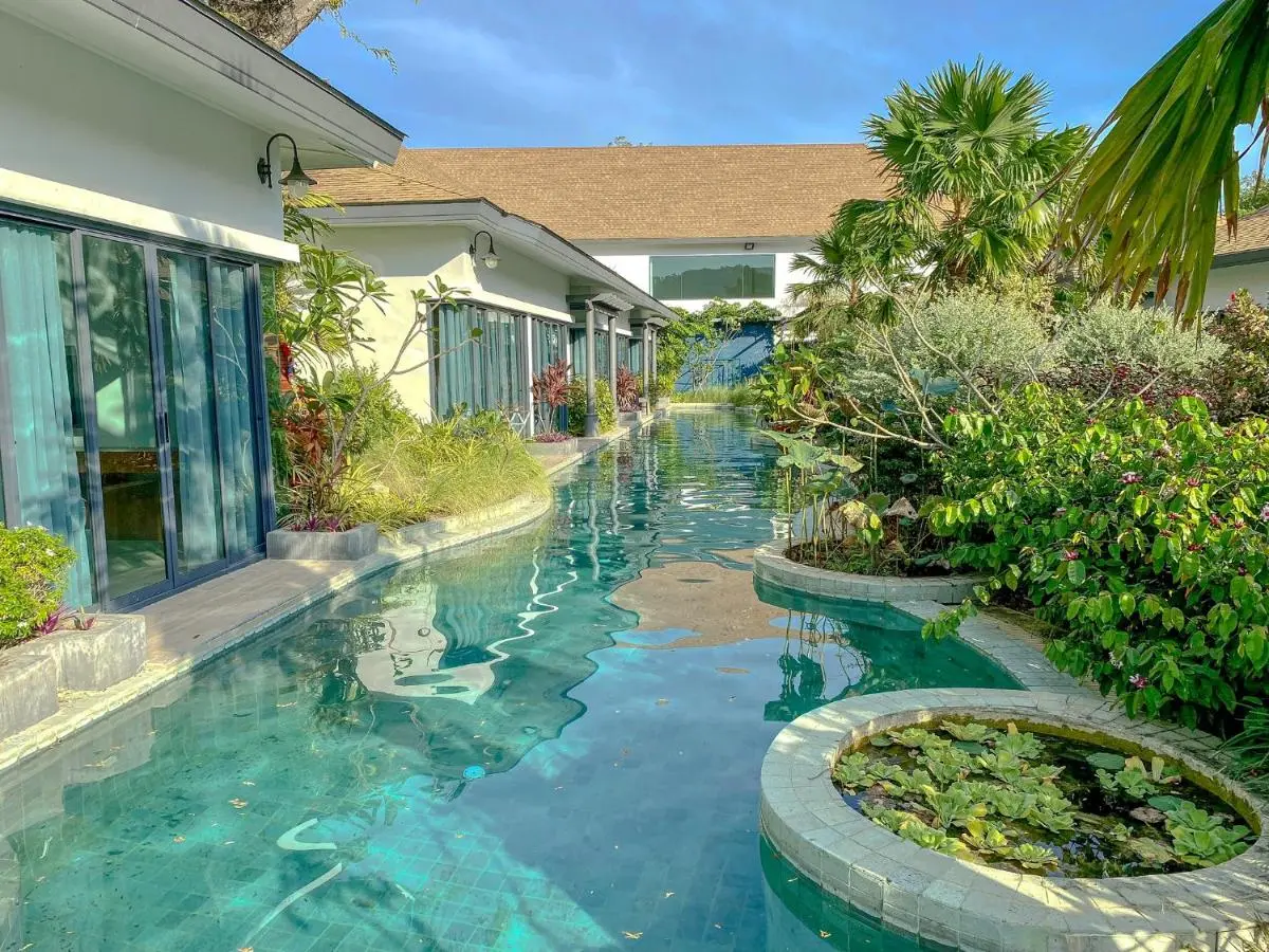 Outdoor Narrow Pool with Aquatic Plants and Lush Greenery in Chalong