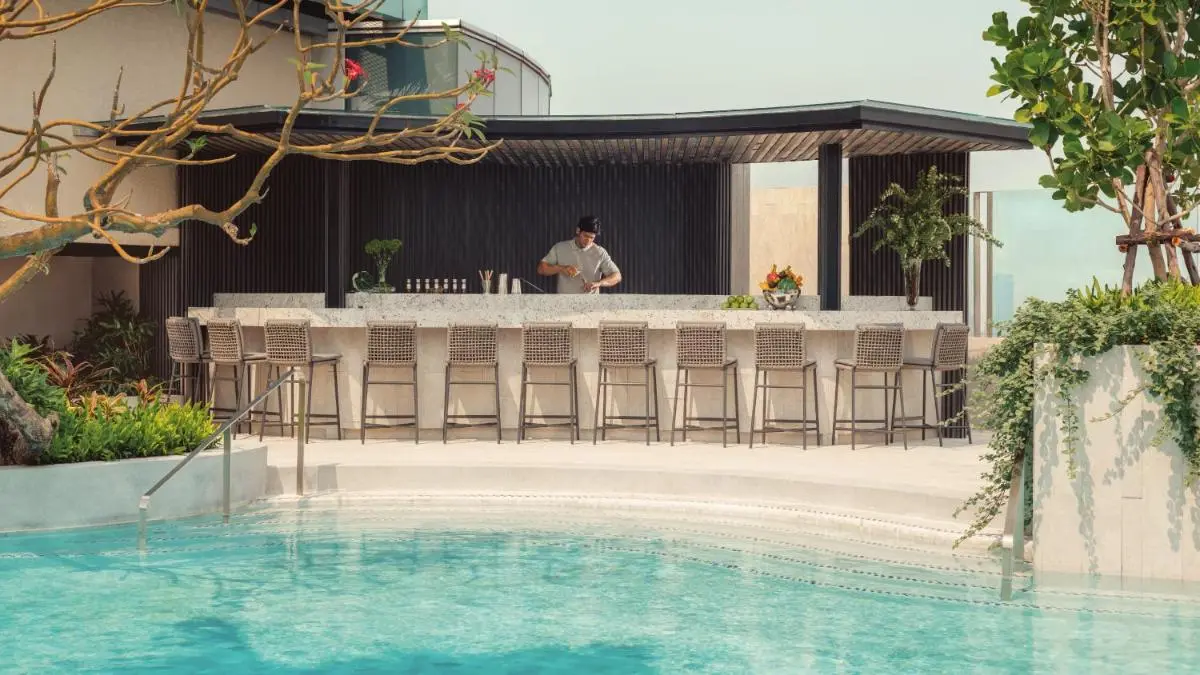 Outdoor Pool and Bar Area with Modern Seating and Landscaping in Pathumwan Bangkok
