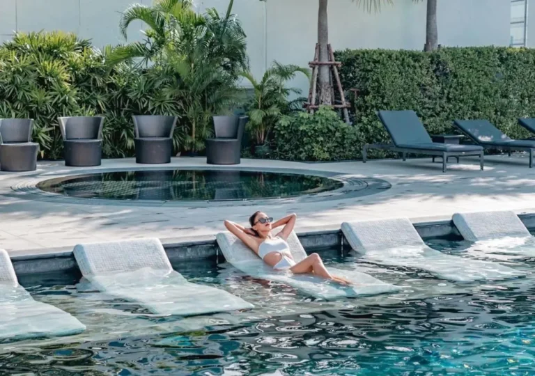 Outdoor Pool and Jacuzzi Area with Lounge Chairs and Tropical Plants in Wattana Bangkok