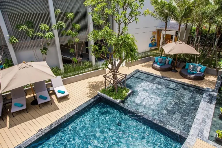 Outdoor Pool and Jacuzzi Area with Lounge Seating and Tropical Landscaping in Patong Beach