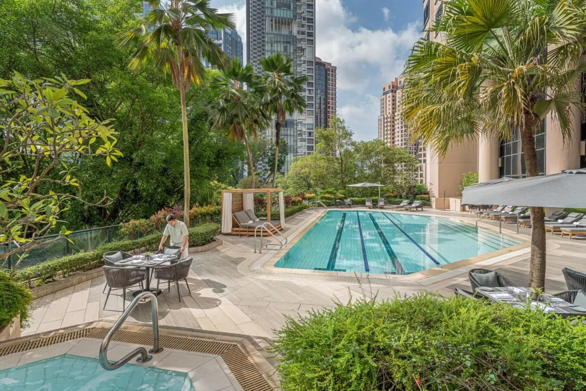 Outdoor Pool and Jacuzzi Area with Lounge Seating in Orchard Urban Setting