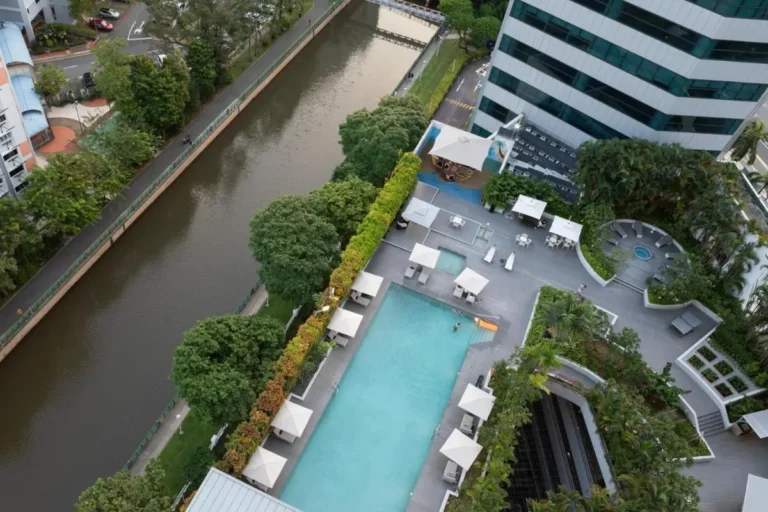 Outdoor Pool and Jacuzzi Area with Seating and Water View in Singapore
