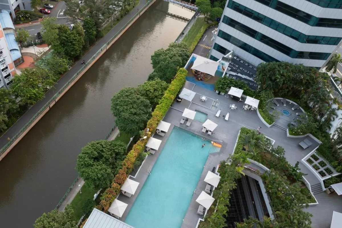 Outdoor Pool and Jacuzzi Area with Seating and Water View in Singapore