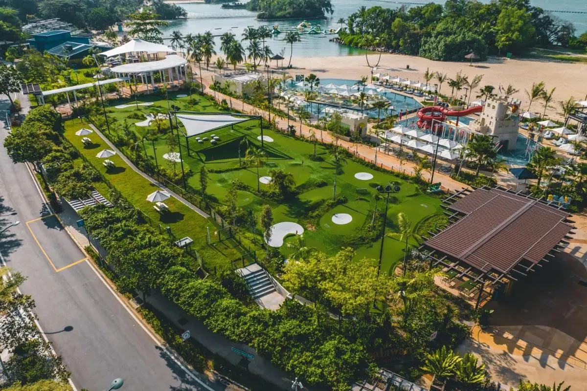 Outdoor Pool and Water Slide Area with Mini Golf Near Waterfront in Singapore