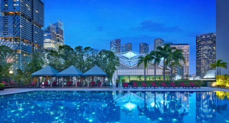 Outdoor Pool Area with Cabanas and Lounge Chairs in Marina Bay Cityscape