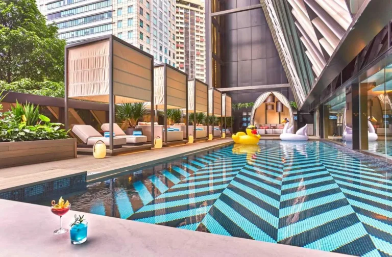 Outdoor Pool Area with Cabanas and Lounge Seating in Orchard Singapore