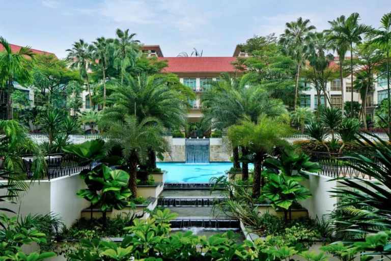 Outdoor Pool Area with Cascading Water Feature and Tropical Landscaping in Singapore