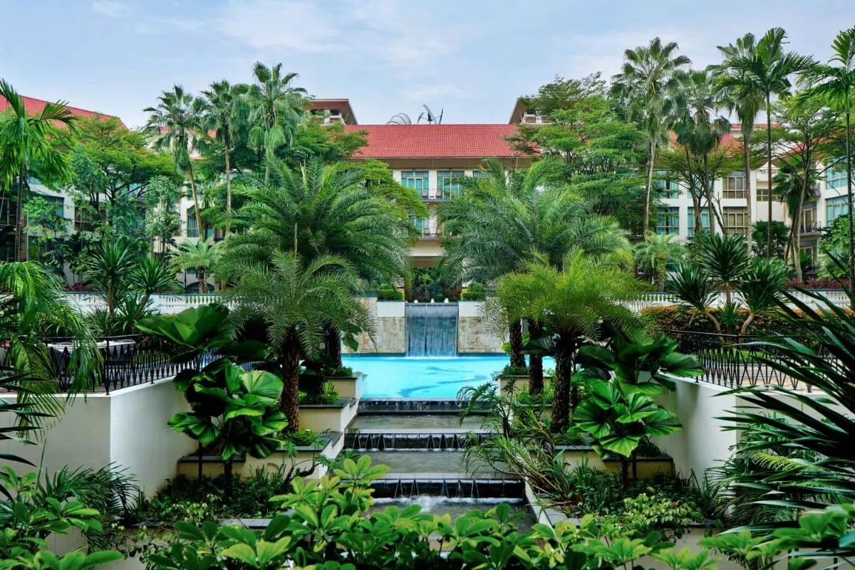 Outdoor Pool Area with Cascading Water Feature and Tropical Landscaping in Singapore