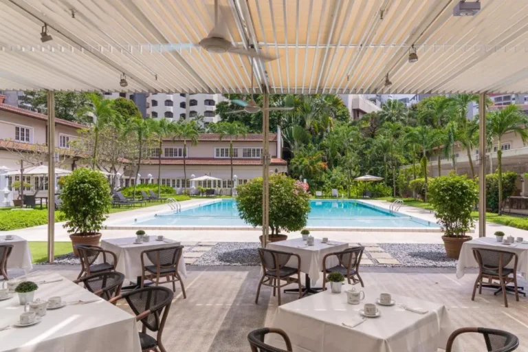 Outdoor Pool Area with Covered Patio Dining and Sun Loungers in Orchard Singapore