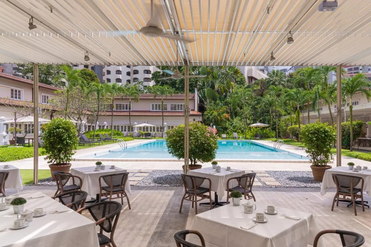 Outdoor Pool Area with Covered Patio Dining and Sun Loungers in Orchard Singapore