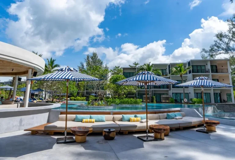 Outdoor Pool Area with Curved Seating and Blue White Umbrellas at Mai Khao Beach