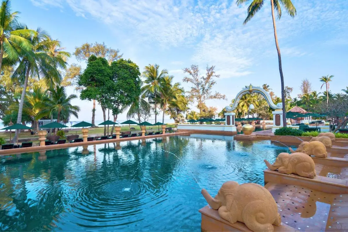 Outdoor Pool Area with Elephant Water Spouts and Tropical Vegetation at Mai Khao Beach