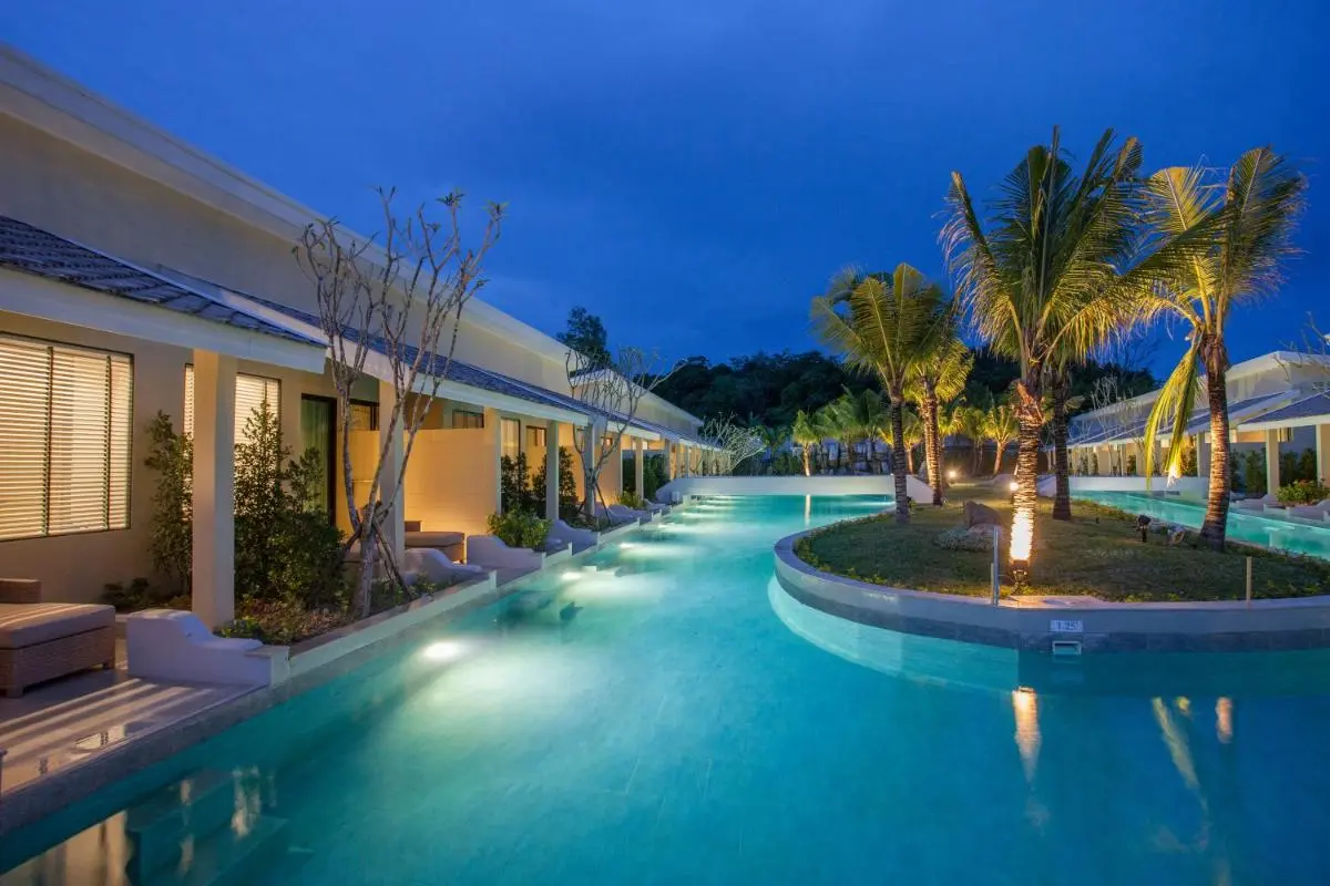 CRAFT Resort & Villas, Phuket Town Outdoor Pool Area with Illuminated Palm Trees and Modern Architecture in Phuket Town