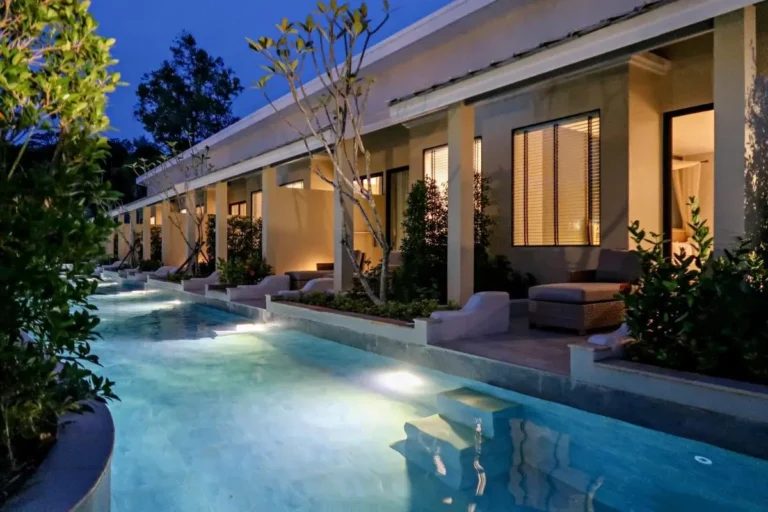 Outdoor Pool Area with Illuminated Water and Comfortable Patio Seating in Phuket Town