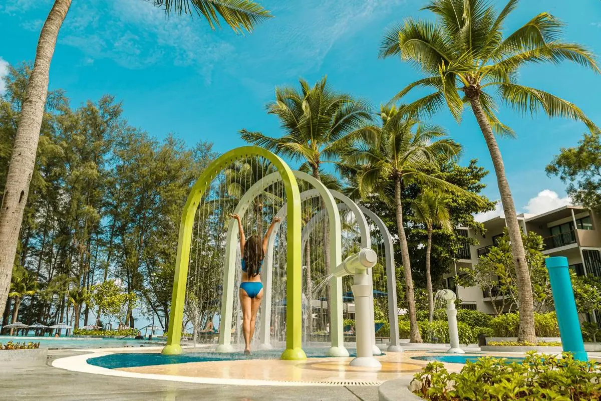 Le Meridien Phuket Mai Khao Beach Resort Outdoor Pool Area with Interactive Water Play Feature and Tropical Surroundings at Mai Khao Beach Phuket Province