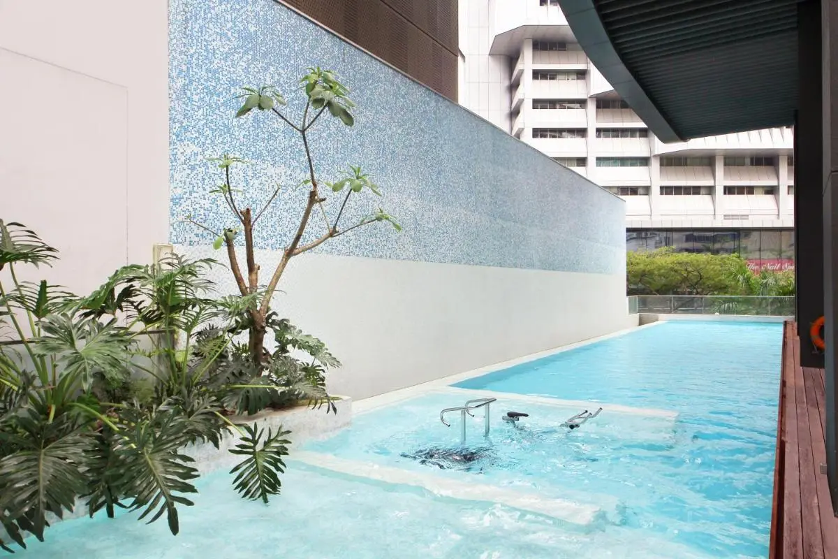 Outdoor Pool Area with Jacuzzi and Spa Features in Singapore Urban Setting