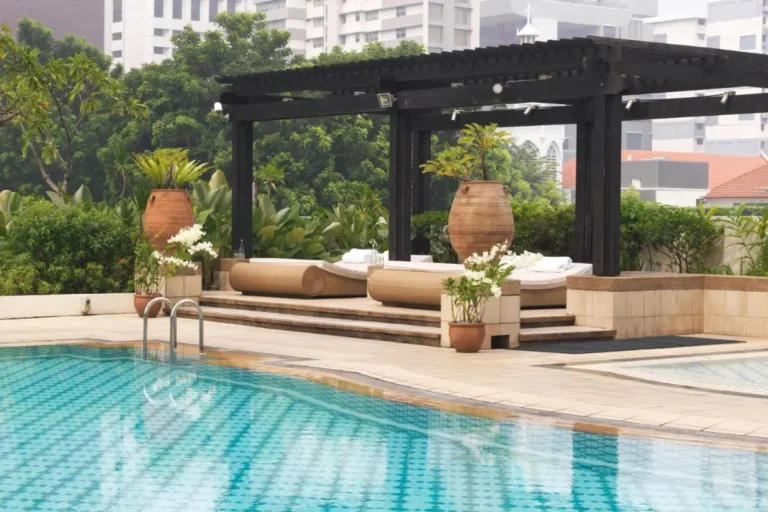 Outdoor Pool Area with Lounge Beds and Pergola in Singapore City