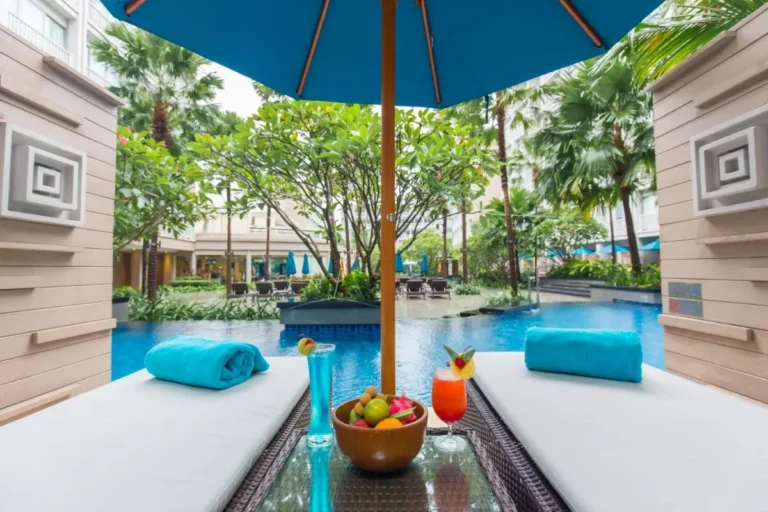 Outdoor Pool Area with Lounge Beds and Tropical Landscaping in Patong Beach Courtyard