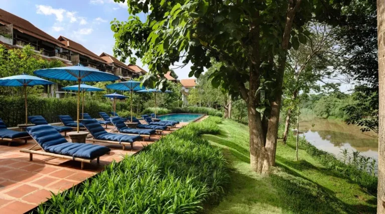 Outdoor Pool Area with Lounge Chairs and Blue Umbrellas in Chiang Mai