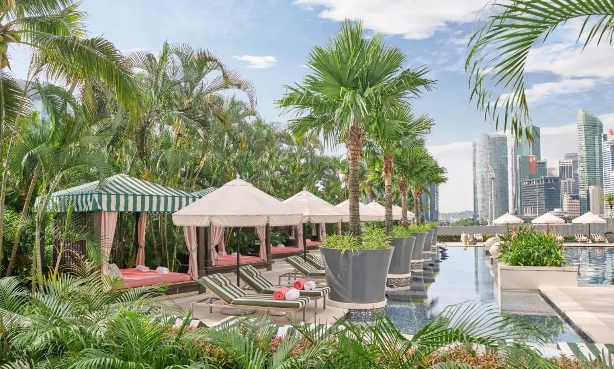 Mandarin Oriental Singapore Outdoor Pool Area with Lounge Chairs and Cabanas in Marina Bay City