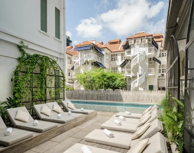Outdoor Pool Area with Lounge Chairs and Greenery in Chinatown Singapore