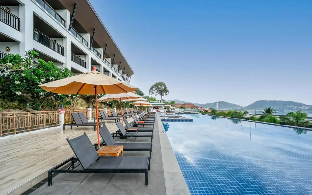 Outdoor Pool Area with Lounge Chairs and Scenic Views Near Patong Beach