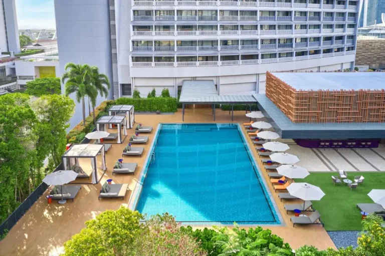 Outdoor Pool Area with Lounge Chairs and Shaded Cabanas in Marina Bay
