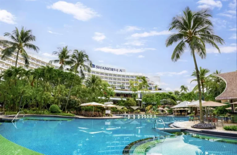 Outdoor Pool Area with Lounge Chairs and Thatched-Roof Seating in Singapore