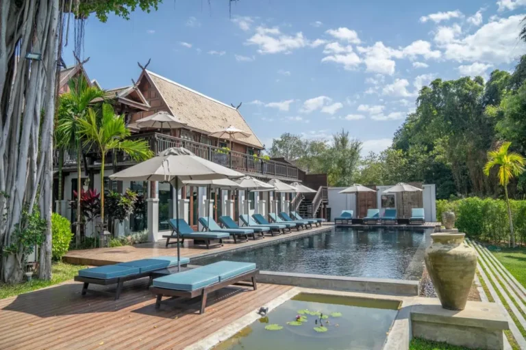 Outdoor Pool Area with Lounge Chairs and Traditional Architecture in Fa Ham Chiang Mai