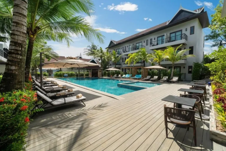 Outdoor Pool Area with Lounge Chairs and Tropical Landscaping in Thalang