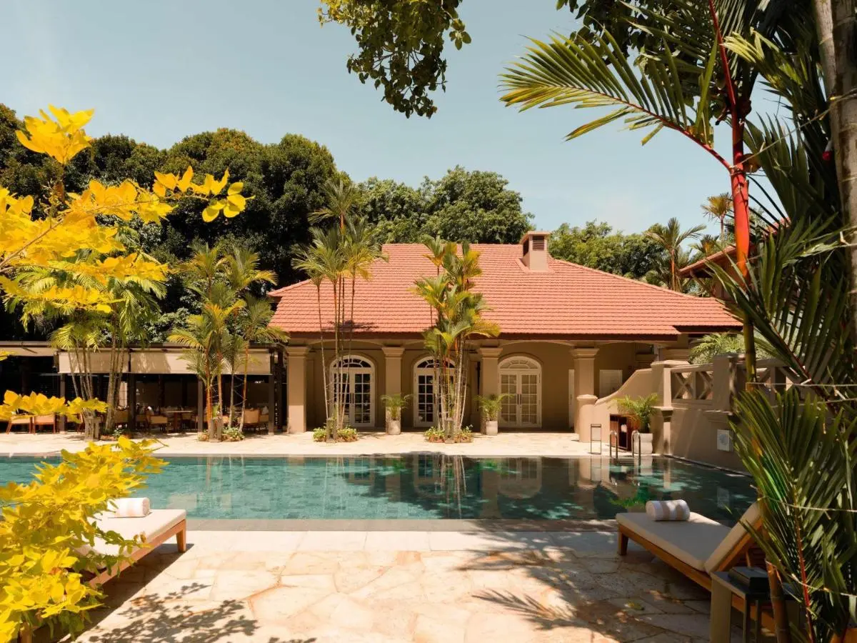 Outdoor Pool Area with Lounge Chairs and Tropical Landscaping on Sentosa Island